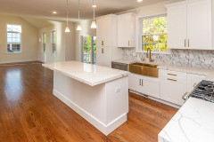 Kitchen with view to two story family room