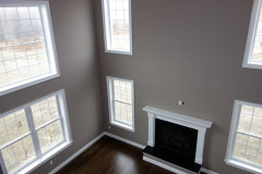 Two story family room with gas fireplace and hardwood floors