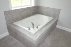 Luxurious tiled bathtub in master bathroom