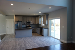 View of open concept modern kitchen from family room