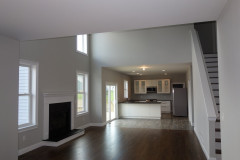 Open floor plan view of the two story family room with gas fireplace