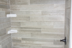 Bathroom tub with standard ceramic tile walls