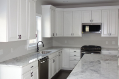Kitchen with standard granite countertops and natural hardwood flooring. Ceramic tile also available