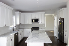 Kitchen with large central island and standard stainless steel GE Appliances