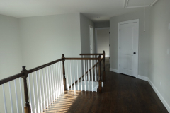Upstairs landing with full-size laundry room, many railing options are available in wood and metal